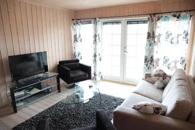 a living room with a couch and a television at Haukelifjell Skisenter in Vågsli