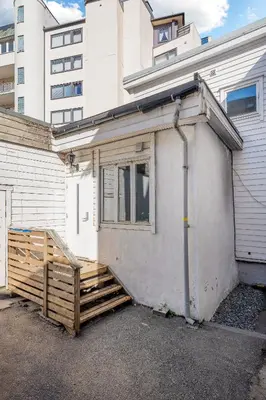 a house with a wooden ramp next to a building at NG Apartments in Bergen