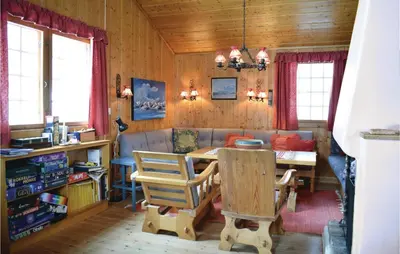 a living room with a table and a couch at 5 Bedroom Stunning Home In Noresund in Noresund