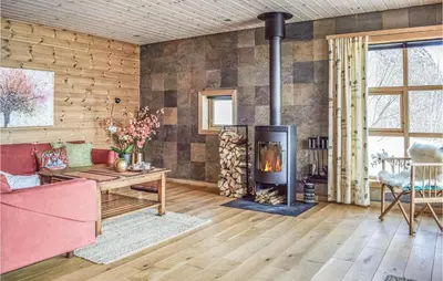 a living room with a fireplace and a couch at Four-Bedroom Holiday Home In Roldal in Røldal