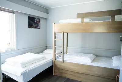 two bunk beds in a room with a window at Hemsedal Cafe Skiers Lodge in Hemsedal