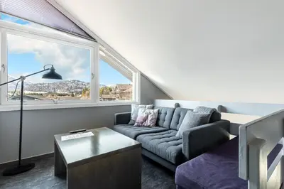 a living room with a couch and a window at Hemsedal Cafe Skiers Lodge in Hemsedal