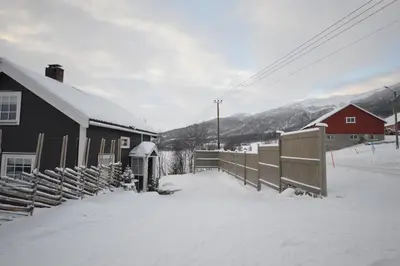 a house with a fence in the snow at Apartment between Ustaoset and Geilo in Geilo