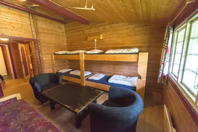 a room with a table and two bunk beds at Dombås Hostel in Dombås