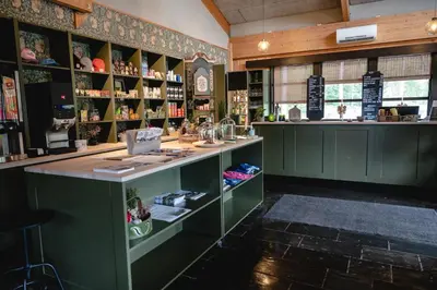 a bar in a room with green cabinets at Dombås Hostel in Dombås