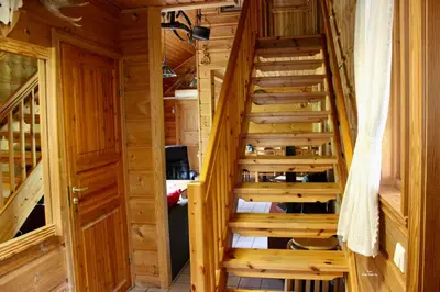 a wooden staircase in a room with wooden walls at Røldalstunet Overnatting in Røldal