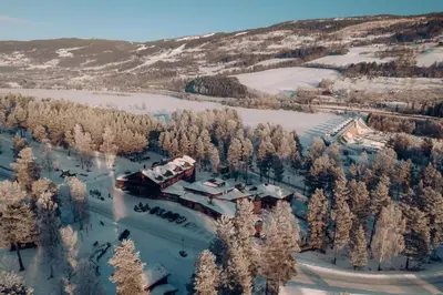 an aerial view of a resort with snow covered trees at Hunderfossen Cottages in Hafjell