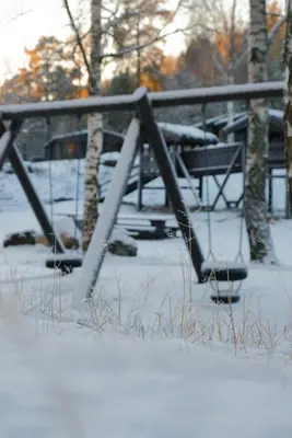 a picnic table covered in snow in a park at Hunderfossen Cottages in Hafjell