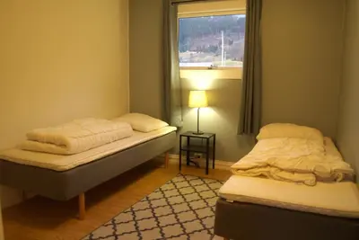 two beds in a room with a window at 5 bedrooms, large apartment with nice view and nature in Herand