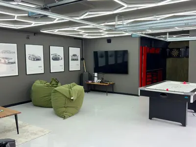a room with a ping pong table and green chairs at Nordica Resort Florø in Florø