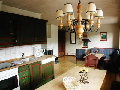 a kitchen with a chandelier and a dining room at Hunderfossen Apartments in Hafjell