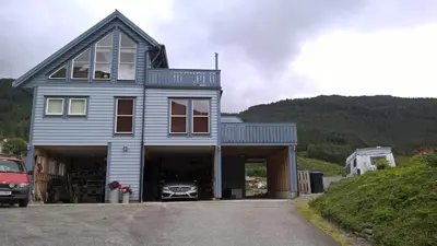 a house with a car in a garage at Apartment 2, Herand, Hardanger in Herand