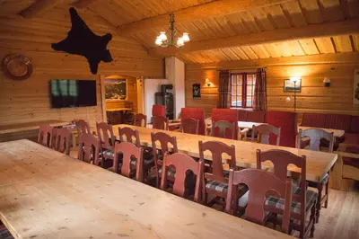 a conference room with a large wooden table and chairs at Hytter Dombås in Dombås