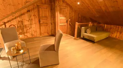 a room with chairs and a bed in a cabin at Trysilsetra 40 in Trysil