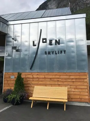 a bench sitting in front of a building at Olden Fjord Apartments in Olden