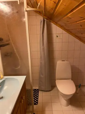 a bathroom with a toilet and a sink at Naustloftet in Hornindal