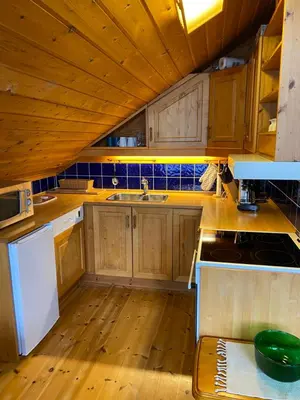 a kitchen with wooden cabinets and a sink at Naustloftet in Hornindal