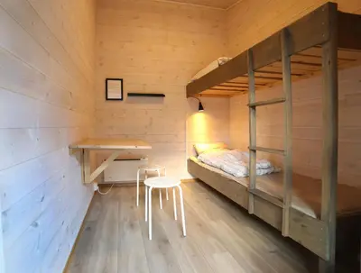 a bedroom with a bunk bed and a desk at Trolltunga Camping in Odda