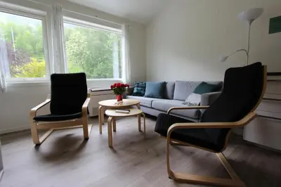 a living room with two chairs and a couch at Trolltunga Camping in Odda
