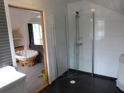 a bathroom with a shower with a glass shower stall at Loftesnes in Sogndal