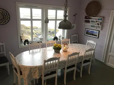 a dining room table with chairs and a table and a table and chairsktop at Finnøya with 180* Atlantic veiw in Finnøy