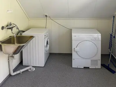 a laundry room with a sink and a washing machine at 6 person holiday home in Onarheim in Onarheim