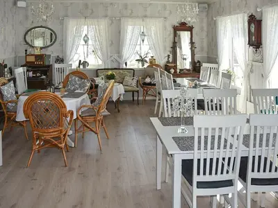 a dining room with white tables and chairs at 6 person holiday home in Onarheim in Onarheim