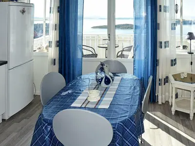 a dining room with a blue table and chairs at 6 person holiday home in Onarheim in Onarheim