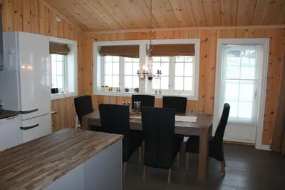 a kitchen and dining room with a table and chairs at Bergestua - 4 bedroom cabin in Gol