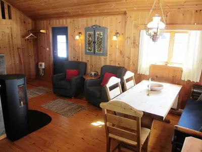 a living room with a dining room table and chairs at Hogstul Hytter - Skojestua - 2 Bedroom Cottage in Tuddal