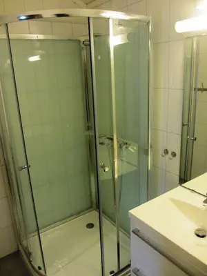 a shower with a glass door in a bathroom at Hogstul Hytter - Skojestua - 2 Bedroom Cottage in Tuddal