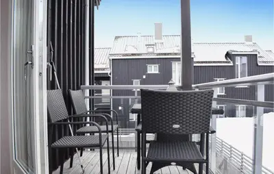 a balcony with chairs and tables on a balcony at Fjellstua C3, Leil 202 in Sjusjøen