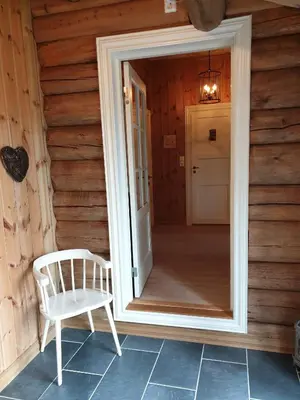 a white chair sitting in front of a door at Koselig familiehytte sentralt på Skeikampen til leie in Svingvoll