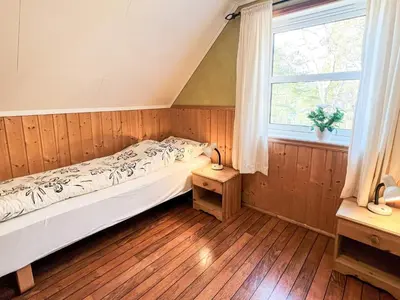 a bedroom with a bed and a window at 6 person holiday home in Leikanger in Leikanger