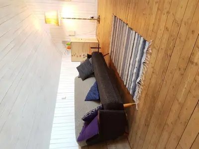 a living room with a couch and a table at Drengestua på Flagstad Østre in Hamar