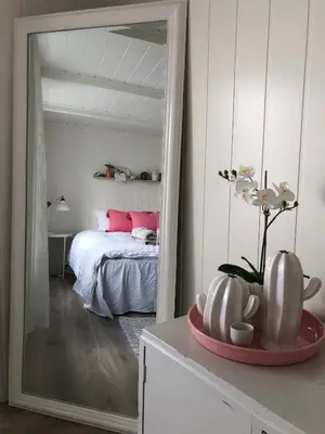 a bedroom with a bed and a large mirror at Olsens Pensjonat in Veiholmen