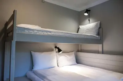 two bunk beds with white pillows in a room at Hemsetunet Apartments in Hemsedal