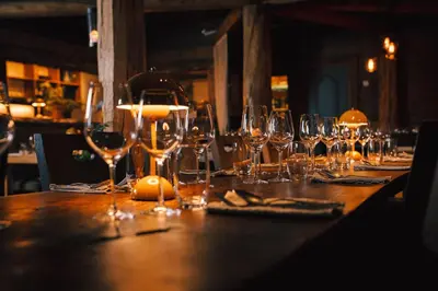 a long wooden table with wine glasses on it at Hemsetunet Apartments in Hemsedal