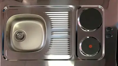 a close up of a metal sink with two mirrors at Rjukan Gjestehus in Rjukan