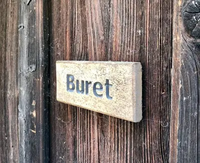 a sign on a wooden door with the word buffet on it at Nutheim Gjestgiveri in Flatdal