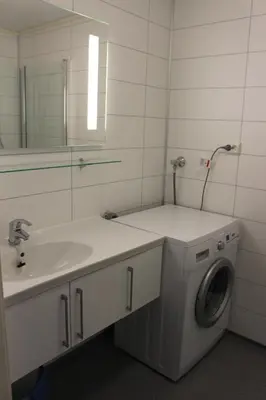 a bathroom with a washing machine and a sink at Briksdalsbre Fjellstove in Briksdalsbre