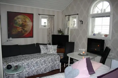 a living room with a couch and a table at Huset på hauen in Volda