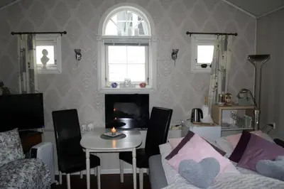 a living room with a couch and a table with a candle at Huset på hauen in Volda