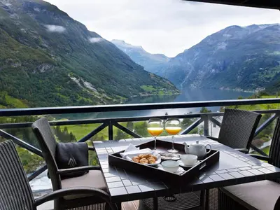 a table with a tray of food and two glasses of wine at Hotel Union Geiranger Bad & Spa in Geiranger