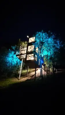 a sign in front of some trees at night at Hardanger Panorama Lodge in Ulvik