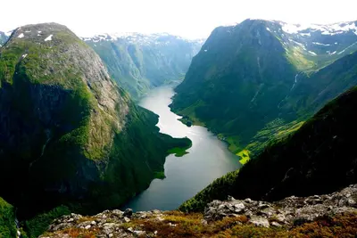 an aerial view of a river between two mountains at Gudvangen Budget Hotel in Gudvangen