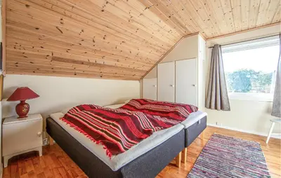 a bedroom with a bed with a wooden ceiling at 5 Bedroom Gorgeous Home In Fjørtoft in Fjørtoft