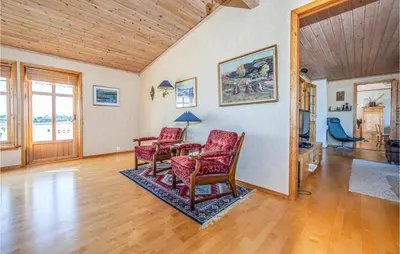 a living room with a table and two chairs at 5 Bedroom Gorgeous Home In Fjørtoft in Fjørtoft
