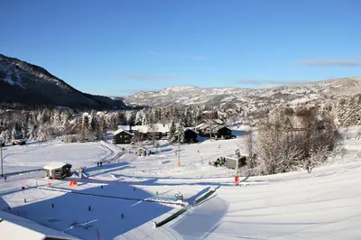 a ski resort in the snow on a mountain at Hafjell Alpinlandsby Pluss in Hafjell