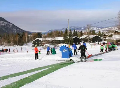 a group of people on skis in the snow at Hafjell Alpinlandsby Pluss in Hafjell